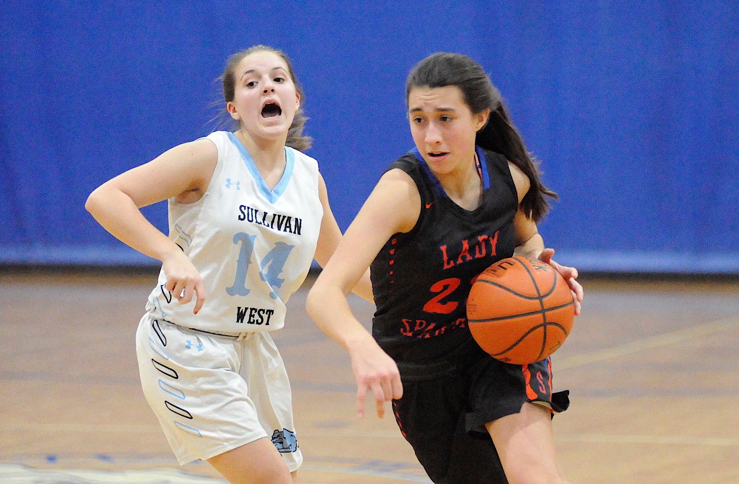 Shock and awe. Sullivan West’s Brielle Arnott registers surprise at the quick reaction time of Seward’s Shannon Sgambick, who posted 15 points at the final buzzer, while Arnott netted 8 including a two 3-pointers.